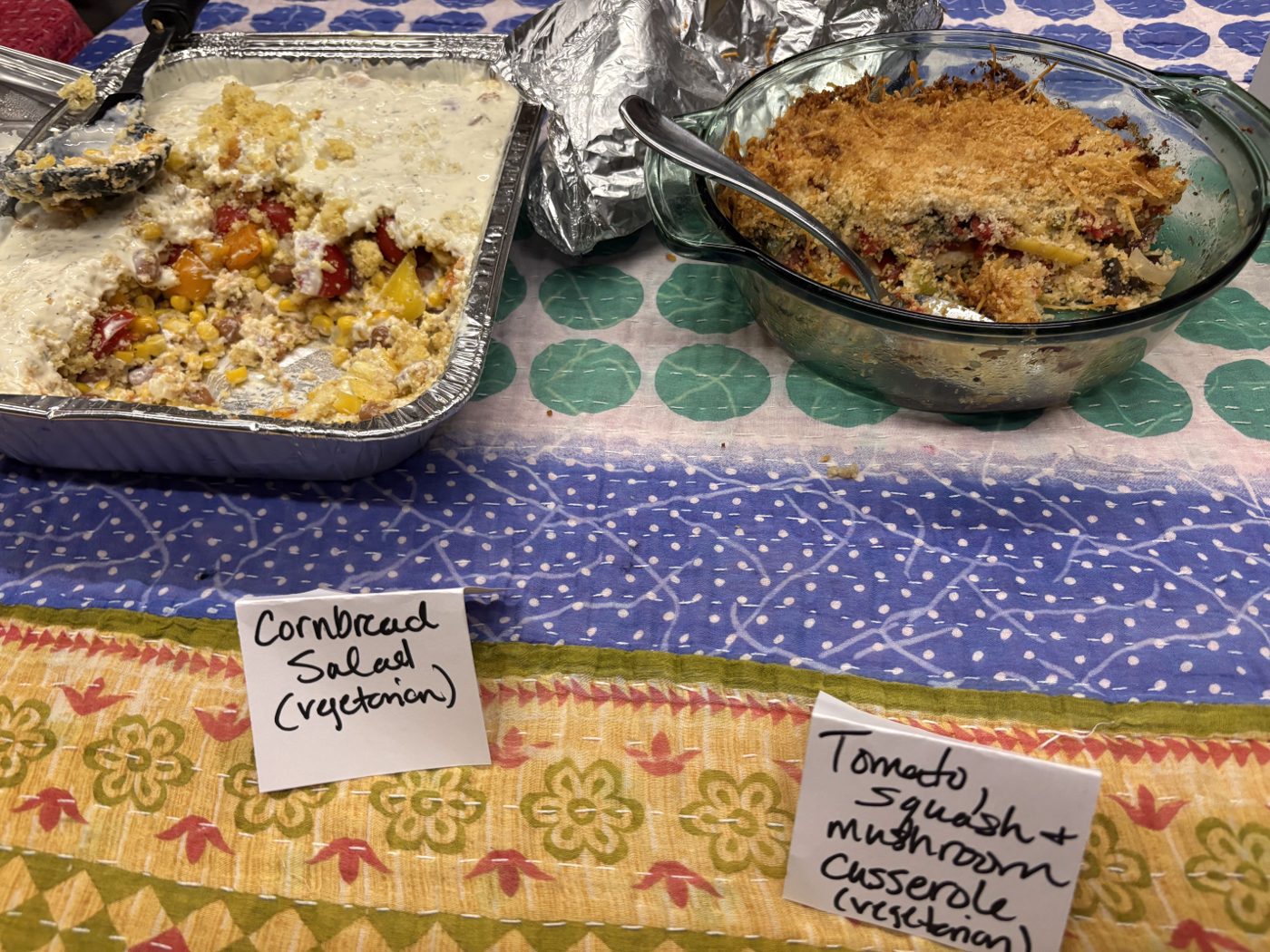 Cornbread salad and a tomato, squash and mushroom casserole, both labeled vegetarian.
