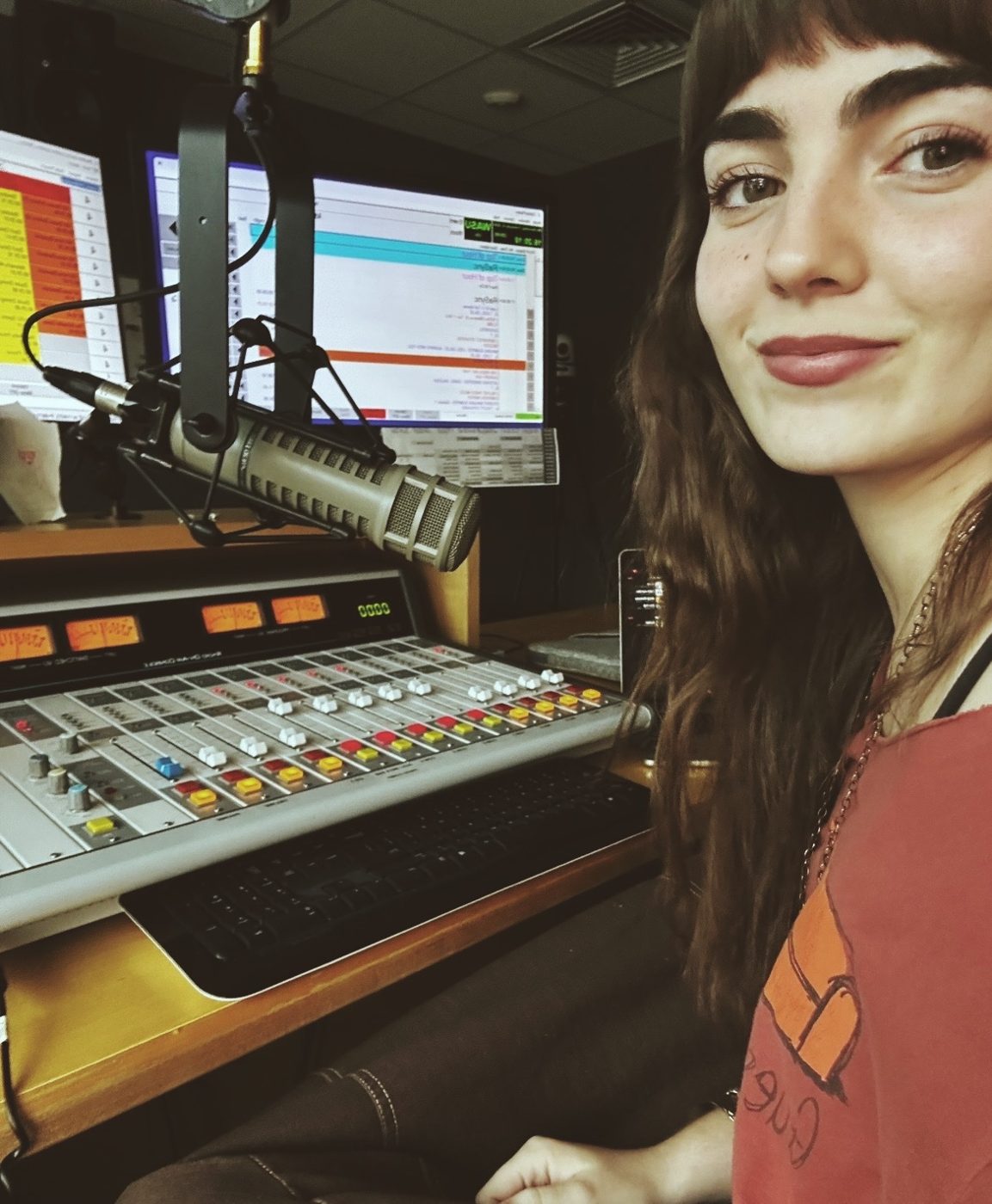 Hattie Atkins, WASU's music director, at the board in the on-air studio.